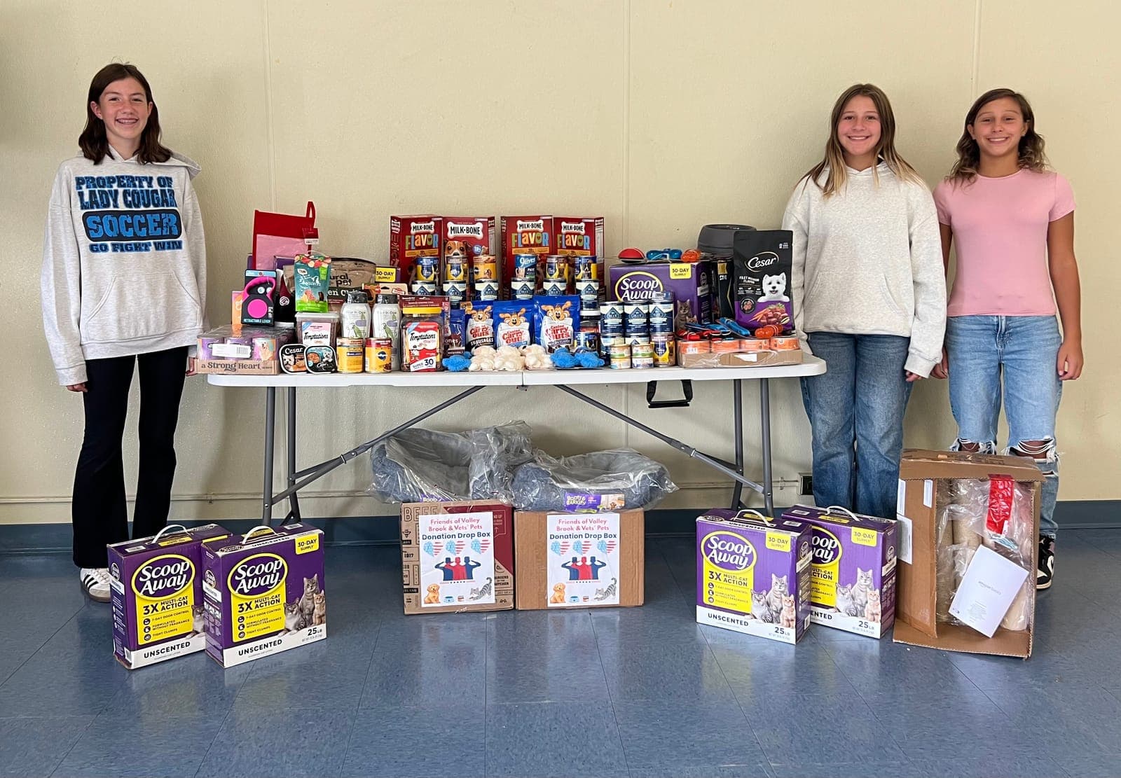 Carl H. Kumpf Middle School students display pet supplies collected through their National Junior Honor Society service project to benefit veterans and their animals.